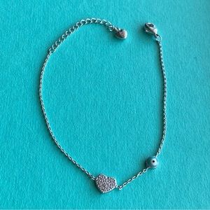 Silver stainless steal evil eye bracelet with heart.